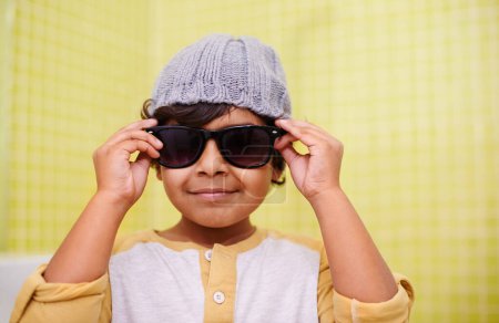 Photo for Child, portrait and sunglasses with smile and fun with vision in a home. Happy, eyewear and youth fashion with an Indian boy with modern and casual style in a house with confidence and frames. - Royalty Free Image