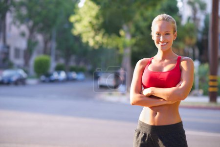 Photo for Happy woman, portrait and confidence with fitness in city for exercise, workout or outdoor training. Young female person, runner or athlete with smile for pride, health and wellness in an urban town. - Royalty Free Image