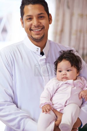 Photo for Muslim, happy and portrait of father with baby in home for bonding, relationship and calm together. Parenting, family and Islamic dad with newborn infant for love, childcare or support in living room. - Royalty Free Image