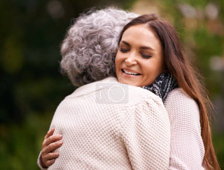 Photo for Hug, mother and woman outdoor with love, embrace and affection for bonding with happiness. Family, elderly female person and daughter with mom in garden, backyard and terrace with smile in nature. - Royalty Free Image