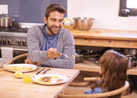Photo for Dad, girl and laugh in morning with breakfast for routine with quality time, happiness and nutrition. Father, child and together for bonding with food, feeding and homemade with love for healthy diet. - Royalty Free Image