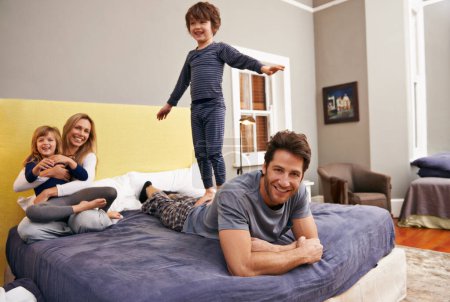 Photo for Home, parents and kids fun on bed with love, support and bonding together with a smile. Happy, family and children with mom in the morning in the bedroom play with sibling in a house with parenting. - Royalty Free Image
