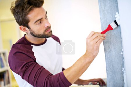 Photo for Painting, paintbrush and man in home for renovation, remodeling and maintenance for white wall. Interior design, construction and person with paint, roller and equipment for DIY project in house. - Royalty Free Image