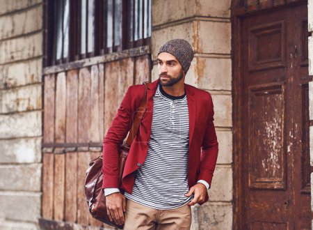 Photo for Fashion, walking and man in city for travel on sightseeing vacation, adventure or holiday. Retro, bag and male person with cool, trendy and winter style for outfit in urban town for weekend trip - Royalty Free Image