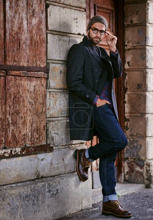 Photo for Fashion, portrait or man by a wall or building in casual clothes, style or edgy coat for a winter outfit. Glasses, cool model or stylish person in an urban town in beanie or trendy jacket in Italy. - Royalty Free Image
