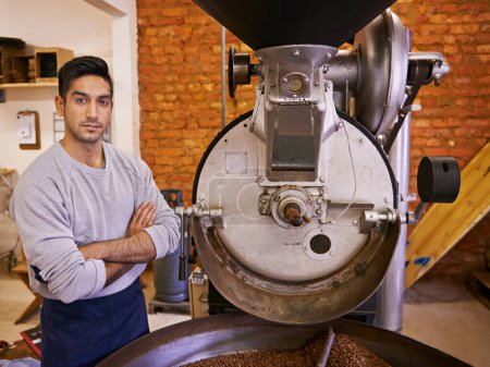 Coffee, small business and portrait of man with roasting machine for blending, production and quality control. Entrepreneur, barista and arms crossed with beans, sustainable cafe and espresso process.