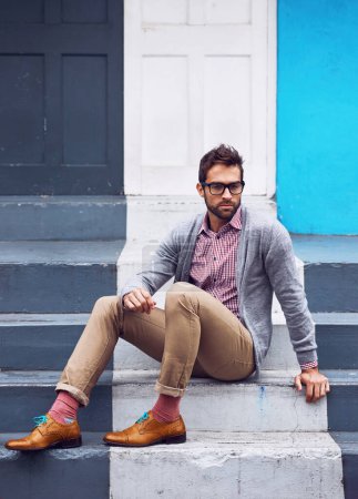 Photo for Serious, fashion and man on stairs in city with stylish, elegant and trendy outfit with confidence. Pride, glasses and person with classy cardigan, shirt and shoes for style by steps in urban town - Royalty Free Image