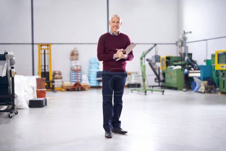 Photo for Checklist, mature or portrait of man in factory with stock in workshop, supply chain or production. Smile, clipboard note or happy manager in warehouse for industrial process, inspection or resources. - Royalty Free Image