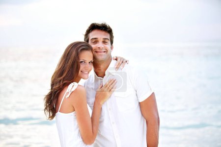 Photo for Happy couple, portrait and hug by beach in nature, love and travel on honeymoon adventure in outdoor. Young man, woman and face of bonding in marriage, sea and together on summer getaway in cape town. - Royalty Free Image