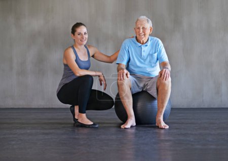 Photo for Portrait, smile and physiotherapist with senior man on ball in gym for rehabilitation, exercise or healthy body. Physical therapy, elderly and happy person with personal trainer for support on mockup. - Royalty Free Image