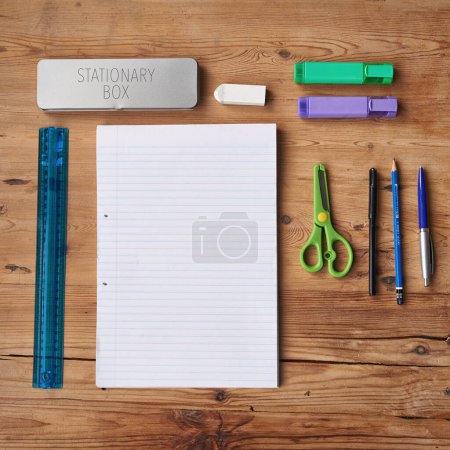 Photo for Desk, notebook and stationery for school project or assignment on creative art, design and drawing. Wooden table, supplies and pen for writing exams or test with blank page for ideas and planning. - Royalty Free Image