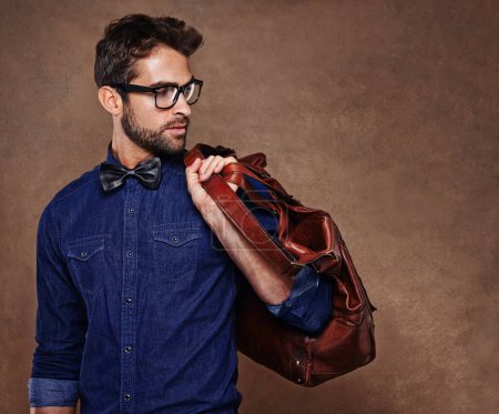 Photo for Travel, fashion and man with bag thinking of vacation in studio, background and mockup for business. Formal, style and luxury leather luggage for airport, journey to Italy and model in glasses. - Royalty Free Image