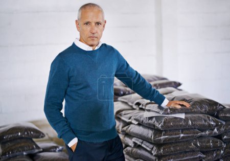 Coffee, storage and portrait of man with bags for distribution, quality control and confident in warehouse. Export, manufacturing and proud entrepreneur with beans at factory for sustainable business.