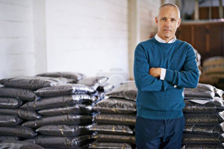 Coffee, warehouse and portrait of man with bags for distribution, quality control and confident logistics. Export, manufacturing and proud entrepreneur with beans at factory for sustainable business.