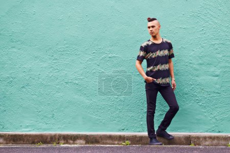 Photo for Man, confidence and serious outdoors for fashion, weekend and casual style for hipster trend. Male person, travel and mockup space by wall background, aesthetic and streetwear or clothes for attitude. - Royalty Free Image
