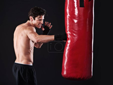 Téléchargez les photos : Man, punching bag and boxing with fitness, training and fighter with gloves, cardio and wellness with endurance. Boxer, practice or athlete with exercise or workout with challenge on black background. - en image libre de droit