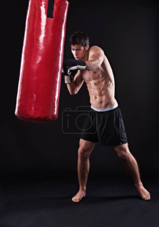 Photo for Man, gloves and boxing bag for exercise practice or cardio workout for health, fighter or black background. Male person, punch and martial arts training in studio on mockup for fitness, gym or fist. - Royalty Free Image