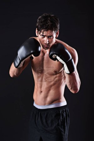 Photo for Man, portrait and boxing gloves in studio for exercise fight or martial arts training or performance, black background or gym. Male person, face and self defence fitness for athlete, mockup or punch. - Royalty Free Image