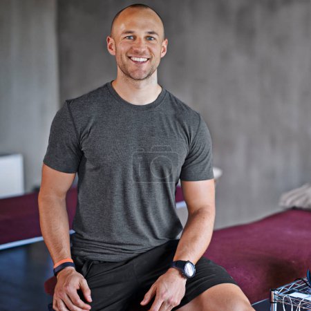 Photo for Physiotherapist, man and portrait on bed smiling for training, health care and wellness. Fitness, athlete or physical therapist ready for consultation professional, happy and prepared for appointment. - Royalty Free Image
