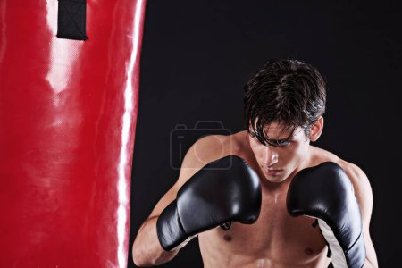 Photo for Man, boxing gloves and bag for fitness practice or cardio exercise for health, fighter or black background. Male person, punch and martial arts training in studio for gym self defence, fist or mockup. - Royalty Free Image