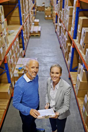 Photo for Portrait, supply chain and man with woman, inventory and warehouse with shipping paperwork and cargo. Clipboard, industry and manufacturing with teamwork or boxes with stock or logistics with storage. - Royalty Free Image
