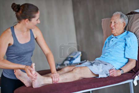 Photo for Woman, chiropractor and senior patient with joint pain in elderly care for muscle or leg injury at clinic. Female person or physiotherapist helping man for consultation, arthritis or ache at hospital. - Royalty Free Image