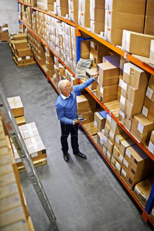 Photo for Tablet, boxes or above of man in factory for delivery order, storage or stock in warehouse for website. Printing, mature manager or supply chain inspection for cargo, package or wholesale shipping. - Royalty Free Image
