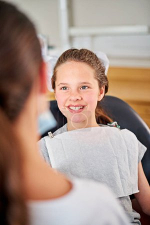 Photo for Happy, child and dentist at checkup appointment in clinic office for oral hygiene and health. Female, patient and orthodontist for braces, filling, cleaning and treatment on teeth from specialist. - Royalty Free Image
