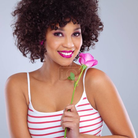 Photo for Portrait, beauty and black woman with flower in studio for skincare, floral cosmetics or dermatology on gray background. Lipstick, pink rose and female model for makeup, glowing skin and eyeshadow. - Royalty Free Image