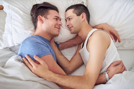 Photo for Smile, men and top view of gay couple in bed at home to relax, embrace and bonding together in the morning. Lgbtq, above and happy people in bedroom for love, connection and healthy relationship. - Royalty Free Image