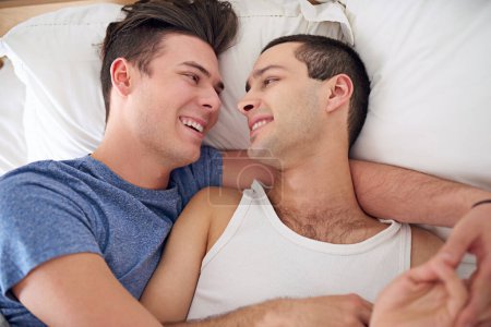 Photo for Men, gay and couple or bed relax in apartment resting with lgbt pride with comfortable love, happiness or connection. Male person, queer and smile with bonding support in home together, calm or peace. - Royalty Free Image