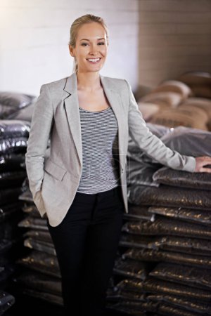 Coffee, warehouse and portrait of business woman with bags for distribution, quality control or confidence. Logistics, manufacturing and proud entrepreneur with beans at factory in sustainable export.