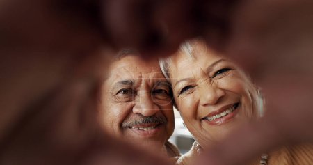 Photo for Happy, selfie and senior couple in a living room with heart, hands or frame zoom in their home together. Smile, portrait and elderly people bond in retirement with profile picture, memory or love. - Royalty Free Image