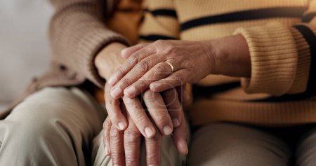 Photo for Senior, couple and hands for empathy on sofa with support, grief and comfort in living room of house. Old people, man and woman with love and embrace for security, compassion and sympathy on couch. - Royalty Free Image