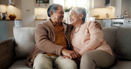 Photo for Senior couple, face and hug on couch, smile and bonding with love, support and relax in retirement in home. Elderly woman, old man and portrait with embrace, together and sitting on living room sofa. - Royalty Free Image