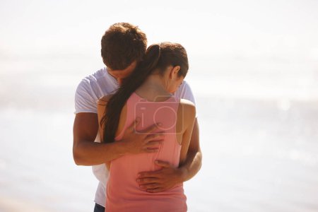 Photo for Couple, hug and comfort at beach with love, woman and man with affection, care and time together outdoor. Safety, security and trust for comfort or support with kindness in relationship and embrace. - Royalty Free Image