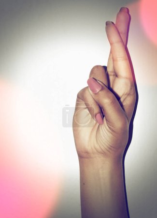 Photo for Hand, fingers crossed and hope for prayer in studio for promotion isolated on a white background mockup space. Palm, wish and closeup of gesture for good luck, winning or communication sign of woman. - Royalty Free Image