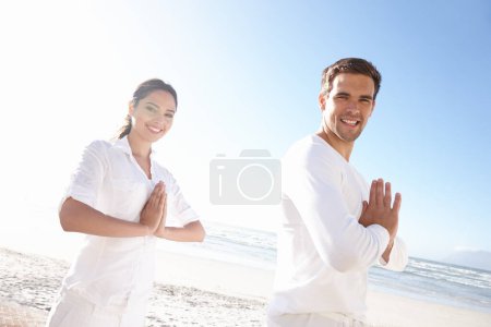 Foto de Retrato, pose de oración y pareja en la playa para retiro de yoga con sonrisa, paz y relax en plena consciencia. Zen, hombre y mujer con meditación para la salud holística, el bienestar espiritual y namaste en el océano. - Imagen libre de derechos
