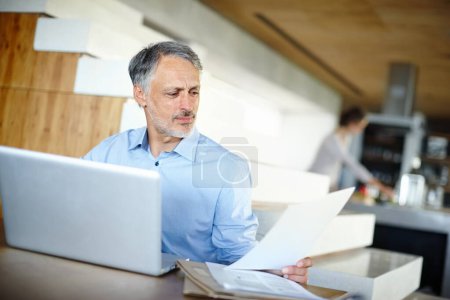 Photo for Mature, businessman and laptop for remote work with document and reading or online research for project. Entrepreneur, computer and paperwork on startup company and learning for small business growth. - Royalty Free Image