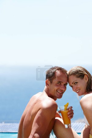 Photo for Couple, portrait and drink with cocktail by swimming pool with space, vacation and love in summer. Man, woman and smile together with pride, alcohol or juice in sunshine, water and holiday in Naples. - Royalty Free Image