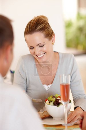 Photo for Glass, woman and salad for eating, nutrition and food at restaurant, cafe and table for date with man. Female person, smile and girl with vegetables for health, wellness and clean diet with husband. - Royalty Free Image