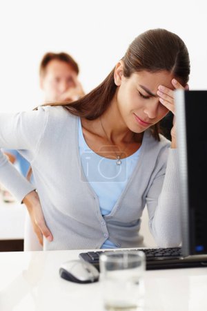 Photo for Woman, back pain and stress in office with computer at work, migraine or headache at workplace. Female employee and tension at desk in workroom with technology, discomfort or injury and difficulty. - Royalty Free Image