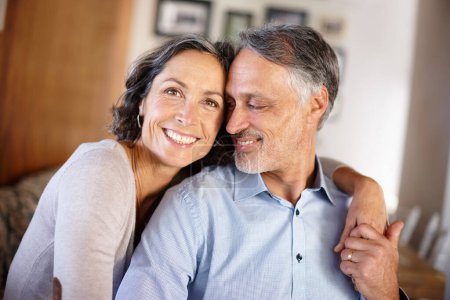 Photo for Mature couple, happy and hug in home for portrait with bonding, care and together with love in living room. Senior people, man and woman with embrace, marriage and holding hands for support in lounge. - Royalty Free Image