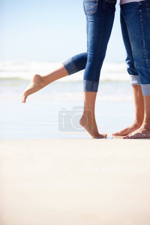 Photo for Love, beach or couple feet in nature with hug, romance or adventure in nature closeup. Legs, zoom or people at ocean for travel, freedom and bonding on sea journey for anniversary, date or honeymoon. - Royalty Free Image