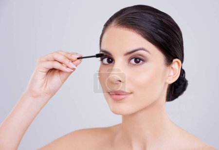 Photo for Makeup, mascara and brush with woman in portrait, beauty for lashes and cosmetology on white background. Skin, glow and transformation for makeover, cosmetic product and wand for eyelash with volume. - Royalty Free Image