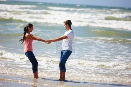 Photo for Couple, holding hands and beach with love for embrace, support or care together on outdoor holiday. Man and woman enjoying summer fun or playing on the ocean coast for bonding together in nature. - Royalty Free Image