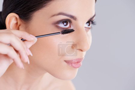 Photo for Beauty, mascara and brush for lashes with woman in studio, makeup and cosmetology on white background. Skin, glow and transformation for makeover, cosmetic product and wand for eyelash with volume. - Royalty Free Image