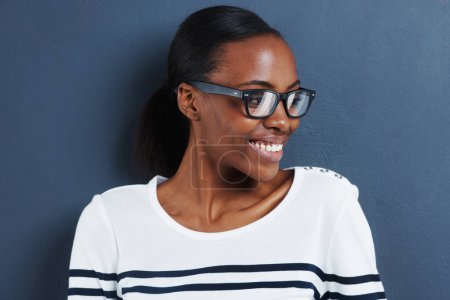 Photo for Glasses, thinking and black woman with smile, ideas or model on grey studio background. African person, mockup space or girl with solution or eyewear with wonder, decision or clear vision with choice. - Royalty Free Image