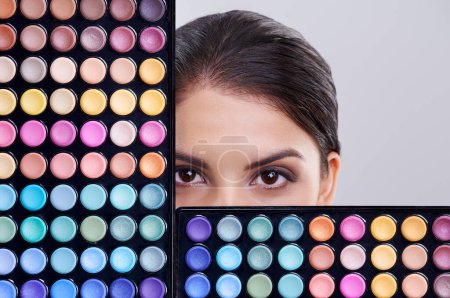 Photo for Beauty, makeup palette and portrait of woman in studio for cosmetics, powder and foundation on gray background. Closeup, skincare and model with cosmetology product, facial glow and eyeshadow. - Royalty Free Image