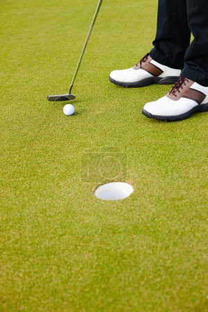 Photo for Feet, club and ball for hole on golf course, contest and practice for competition or tournament. Closeup, shoes and target for outdoor challenge and exercise, game and athlete for international match. - Royalty Free Image